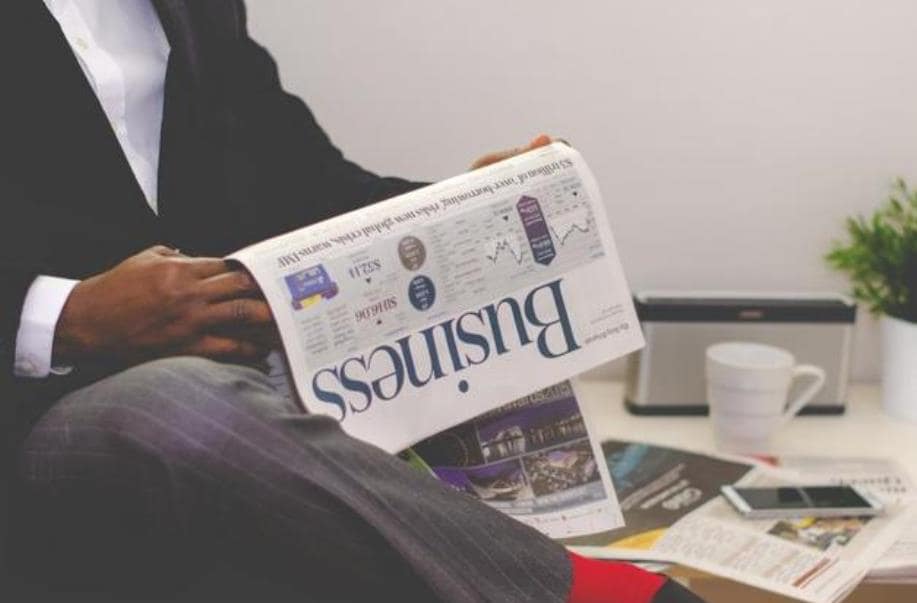 man reading a news from the news paper
